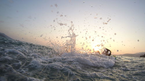 Close-up of sea water against sky during sunset