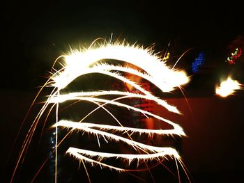 Low angle view of firework display at night