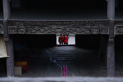 Rear view of man standing at entrance of temple