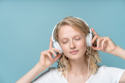 Young woman using smart phone against white background