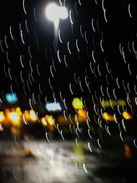 Low angle view of illuminated lights at night