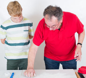 People making cookies on table at home