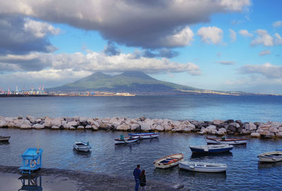 High angle view of man and woman standing on shore