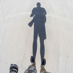 Low section of man standing on ground