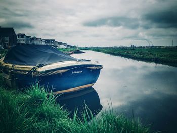 Boats moored in lake against sky