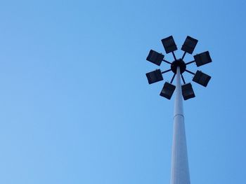 Low angle view of floodlight against clear blue sky