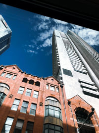 Low angle view of modern buildings against sky