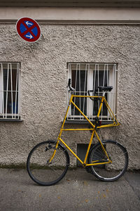 Bicycle sign on road against building