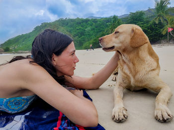 Young woman with dog sitting outdoors