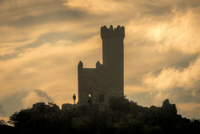 Low angle view of tower against sky during sunset