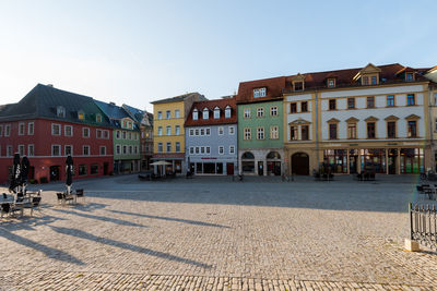 Buildings in city against clear sky