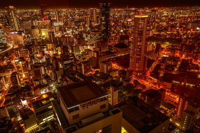 High angle view of city lit up at night