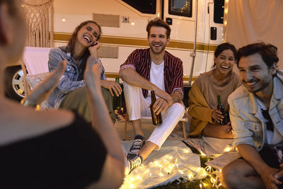 Friends having party at night during picnic