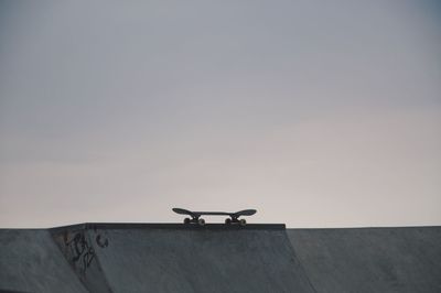 Skateboard at skateboard park against clear sky