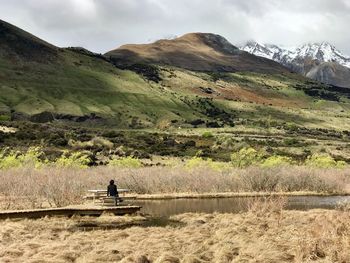 Scenic view of lake and mountains against sky