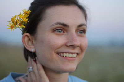 Close-up of smiling young woman looking away