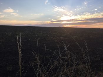 Scenic view of landscape against sky at sunset