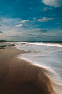 Scenic view of beach against sky