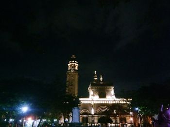 Low angle view of illuminated building against sky at night