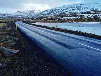 Empty road against snowed landscape