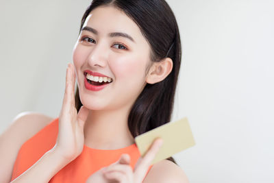 Portrait of a smiling young woman over white background