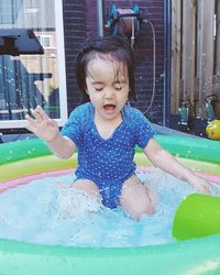 Cute girl playing in swimming pool