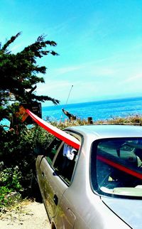 Close-up of car on sea against sky