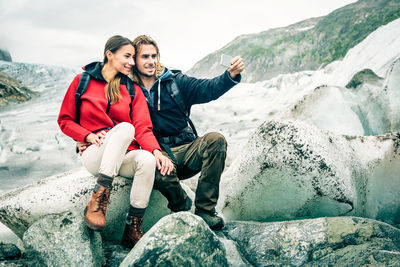 Friends sitting on rock