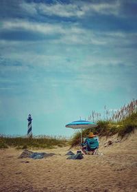 Lifeguard hut on beach against sky