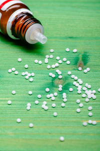 Close-up of homeopathic medicines on green table