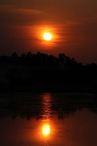 Scenic view of lake against romantic sky at sunset