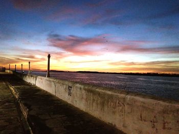 Scenic view of beach against sky during sunset