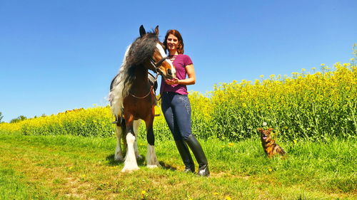 Woman with dog on field