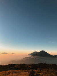 Scenic view of mountains against clear sky during sunset