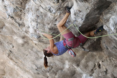 Full length of man climbing on rock