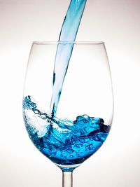 Close-up of wine glass against white background