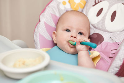 High angle view of cute baby girl with food