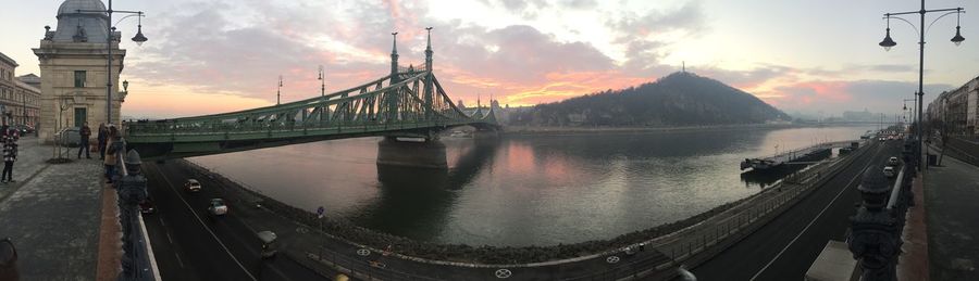 Panoramic view of danube river with liberty bridge against sky during sunset