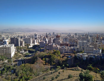 High angle view of buildings against clear blue sky