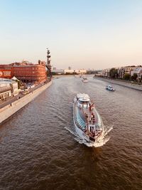 View of bridge over river in city at sunset