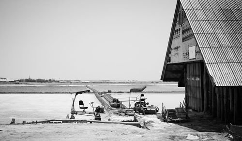 People at beach against clear sky