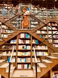 Rear view of man standing on staircase