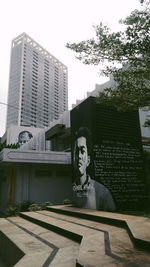 Low angle view of statue against building in city