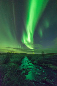 Scenic view of landscape against sky at night