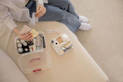 High angle view of doctor examining patient at home