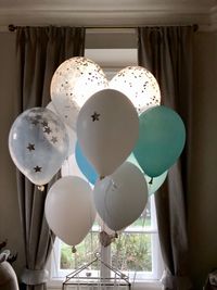 Low angle view of balloons hanging at home