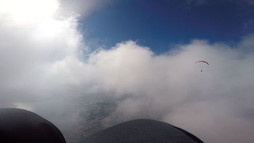 Low angle view of paragliding against sky