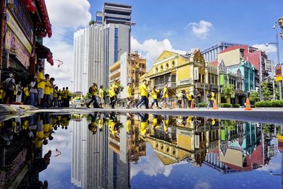 Reflection of buildings in puddle on lake