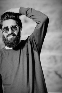 Portrait of bearded young man wearing sunglasses standing outdoors