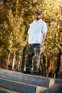 Full length of man standing on skateboard